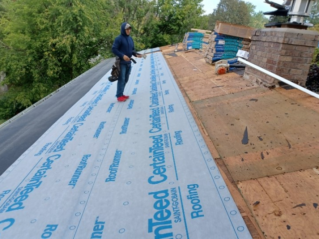 Ice and water shield being installed on a new roof in Hopkins, MN