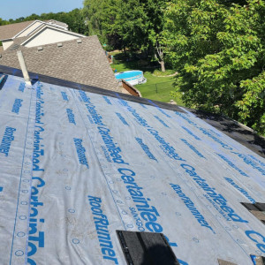 Roofing underlayment installation by Iron River Construction.